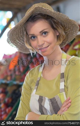 cheerful beautiful young female seller wearing apron