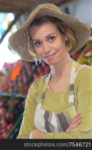 cheerful beautiful young female seller wearing apron