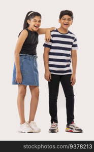 Cheerful boy and girl standing together against white background