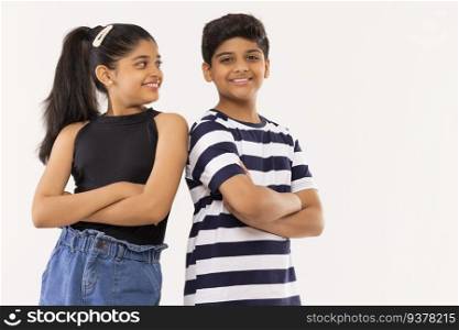 Cheerful boy and girl standing together with crossed arms