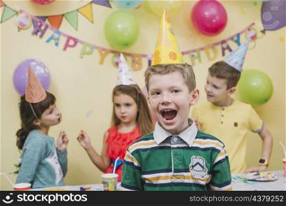 cheerful boy celebrating birthday with friends