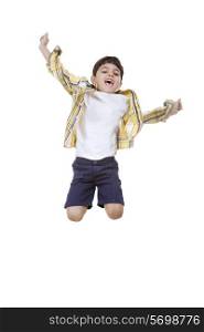 Cheerful boy jumping over white background