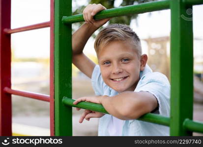 cheerful boy playing alone playground