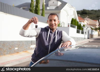 Cheerful boy with keys in hand of her new car