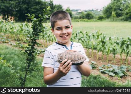 cheerful boy with turtle garden