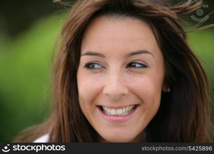 Cheerful brunette stood outdoors