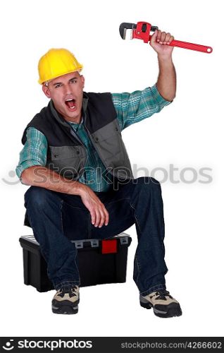 Cheerful builder sat on tool box