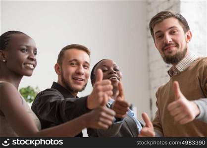 Cheerful business group giving thumbs up