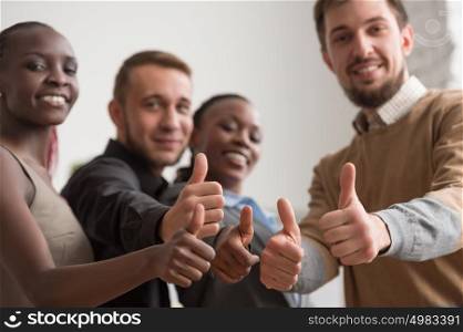 Cheerful business group giving thumbs up