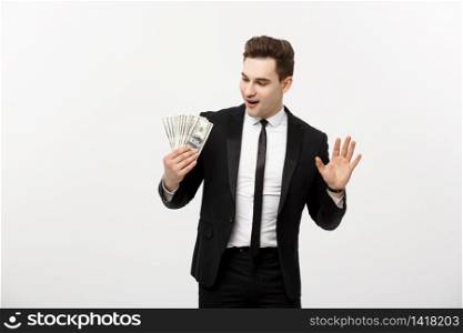 Cheerful businessman holding group of dollar bills on a gray background. Cheerful businessman holding group of dollar bills on a gray background.