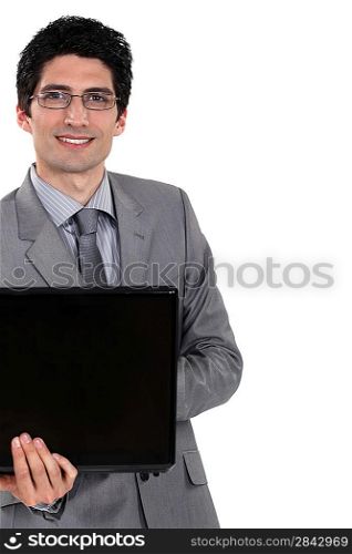 Cheerful businessman holding laptop computer