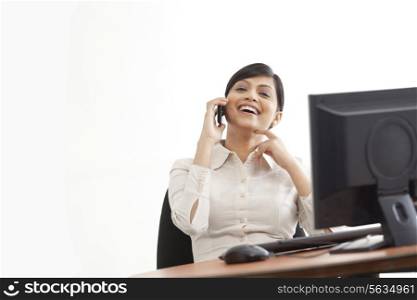 Cheerful businesswoman enjoying conversing on call