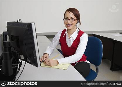Cheerful Businesswoman Sitting at Desk
