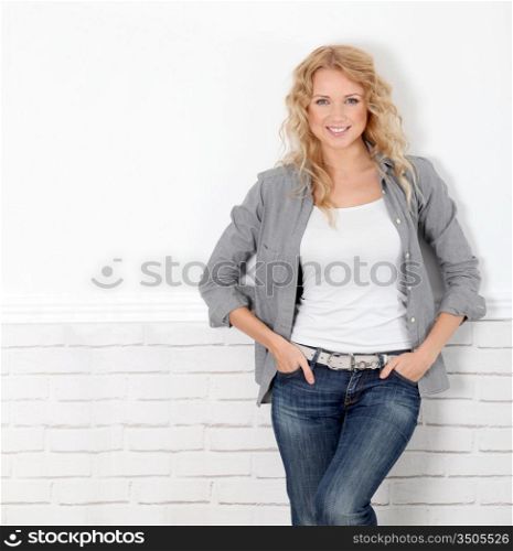 Cheerful casual woman standing on white background