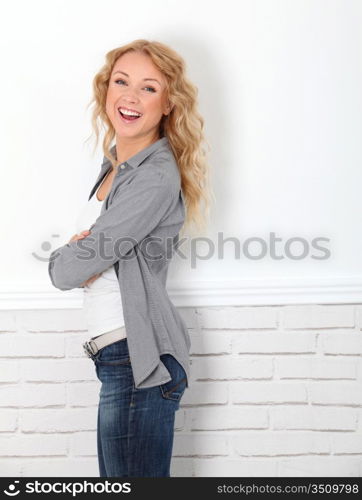 Cheerful casual woman standing on white background
