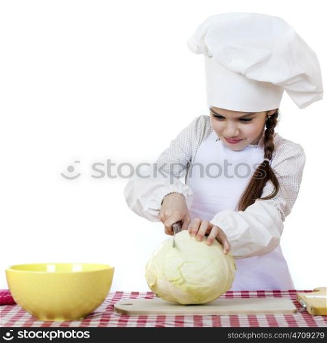 Cheerful caucasian little girl in cook hat holding a head of cabbage, isolated on white background