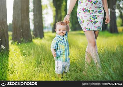 Cheerful child holding mom&rsquo;s hand