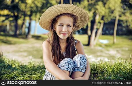 Cheerful child resting on fresh, summer lawn