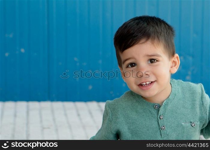 Cheerful child with two years making gestures on the street
