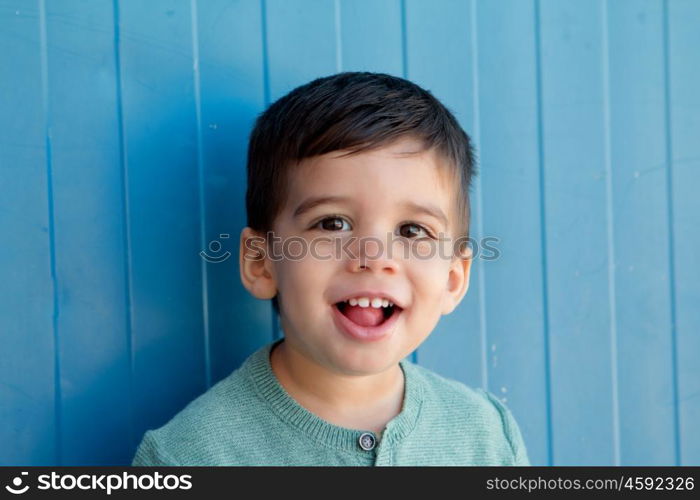 Cheerful child with two years making gestures on the street