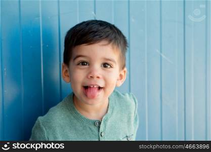 Cheerful child with two years making gestures on the street