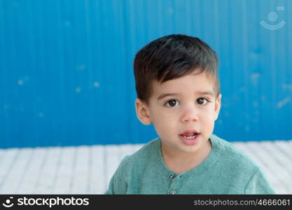 Cheerful child with two years making gestures on the street