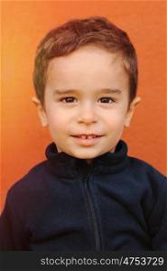Cheerful child with two years on a orange background