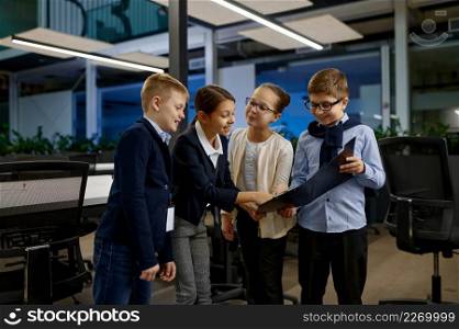 Cheerful children team laughing in business office. Happiness, positive feeling and emotion. Positive children team laughing in business office