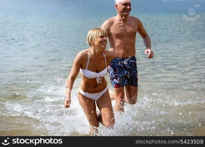 Cheerful couple bathing in the sea