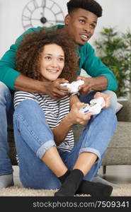 cheerful couple playing video games at home