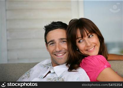 Cheerful couple sitting on a sofa