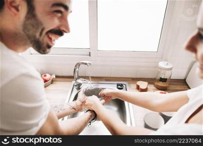 cheerful couple washing jug