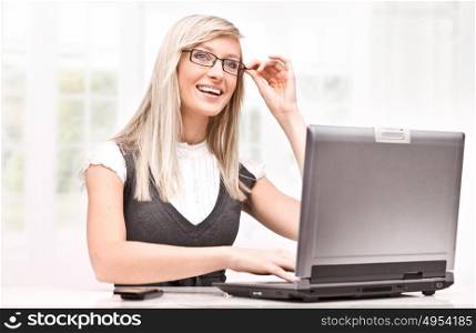 Cheerful emplyee worikng with a laptop