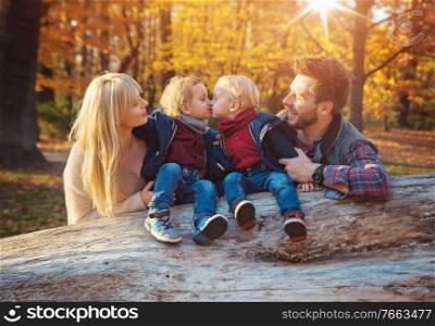 Cheerful family enjoying an autumn weather in a forest
