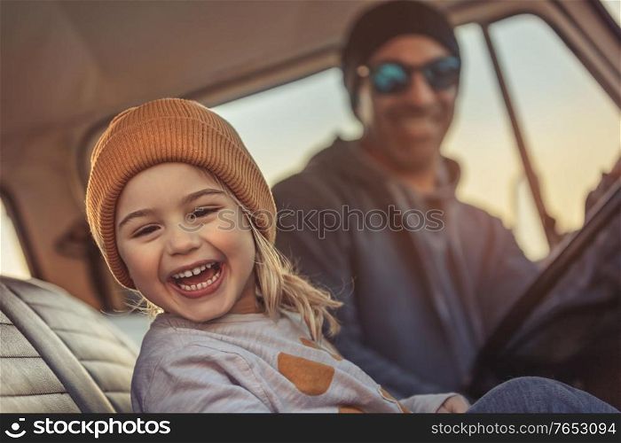 Cheerful Family Having Fun Together in the Car. Enjoying Road Trip. Father with Pleasure Teaching his Little Son to Driving Auto. Happy Fatherhood.