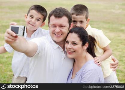 Cheerful family of five taking self portrait on natural background