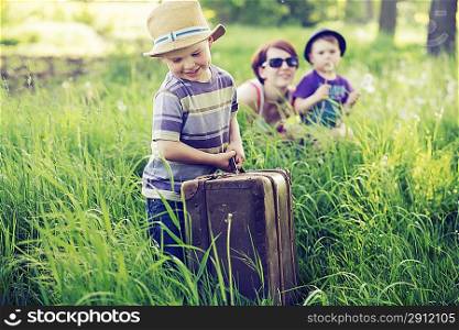 Cheerful family playing on tal greenl grass