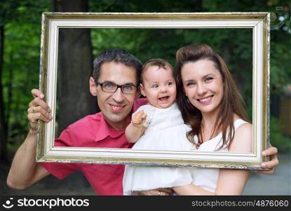 Cheerful family posing with the retro frame