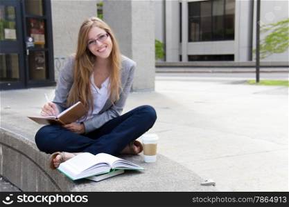 Cheerful female student studying on campus