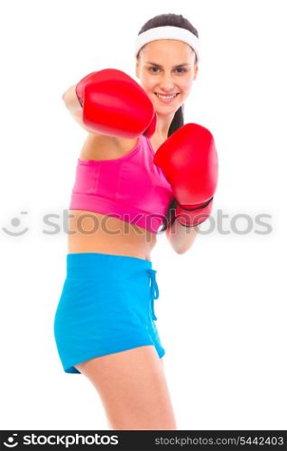 Cheerful fit young girl in boxing gloves punching isolated on white&#xA;