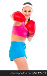 Cheerful fit young girl in boxing gloves punching isolated on white&#xA;