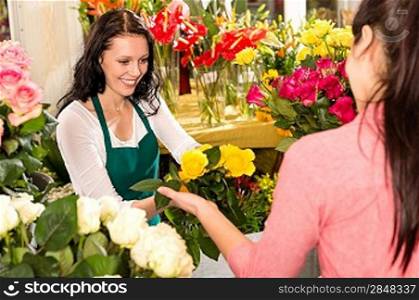 Cheerful flower shop florist customer buying yellow bouquet women