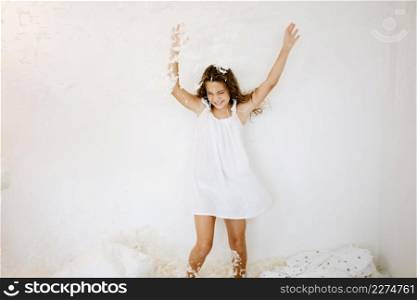 cheerful girl jumping falling feathers