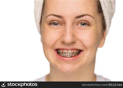 Cheerful girl with braces morning hygiene on white background