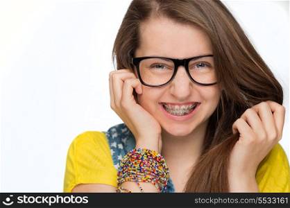 Cheerful girl with braces wearing geek glasses on white background