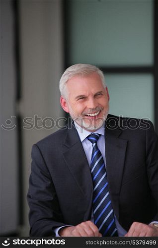 Cheerful gray-haired businessman