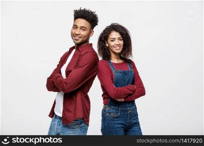 Cheerful hsppy man and woman with crossed hands standing back to back. Cheerful hsppy man and woman with crossed hands standing back to back.