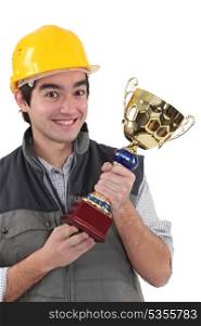 Cheerful laborer with gold cup