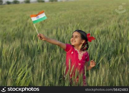 Cheerful little girl holding Indian flag