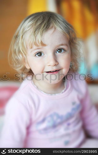 cheerful little girl sits on bed of parents